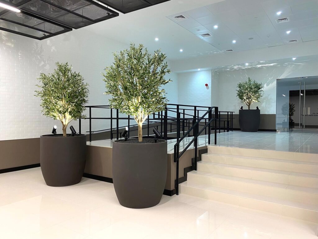 Artificial trees in the custom pots in the hall